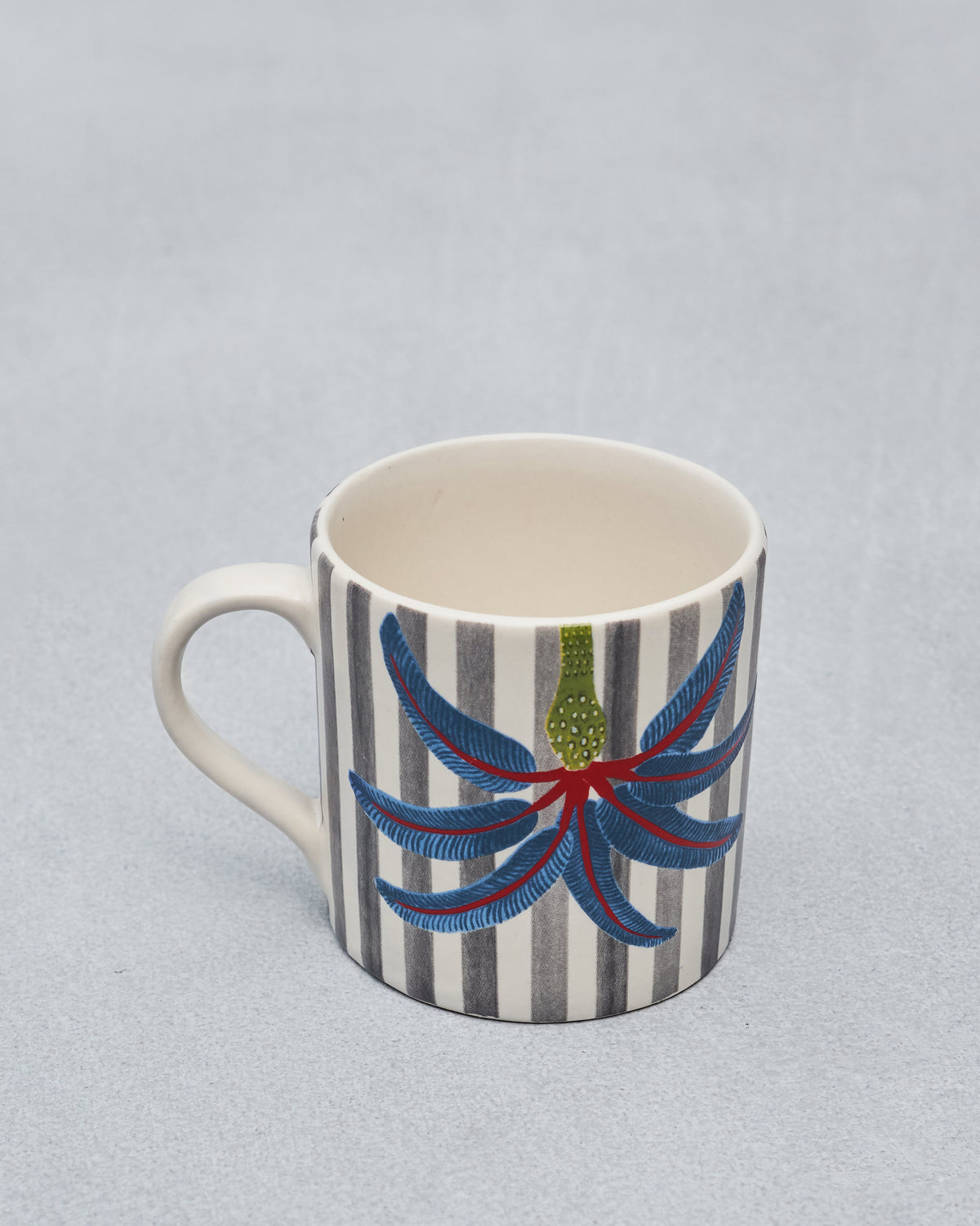 Dancing Palm Straight Mug with a cream handle, grey stripes, and a blue palm motif.