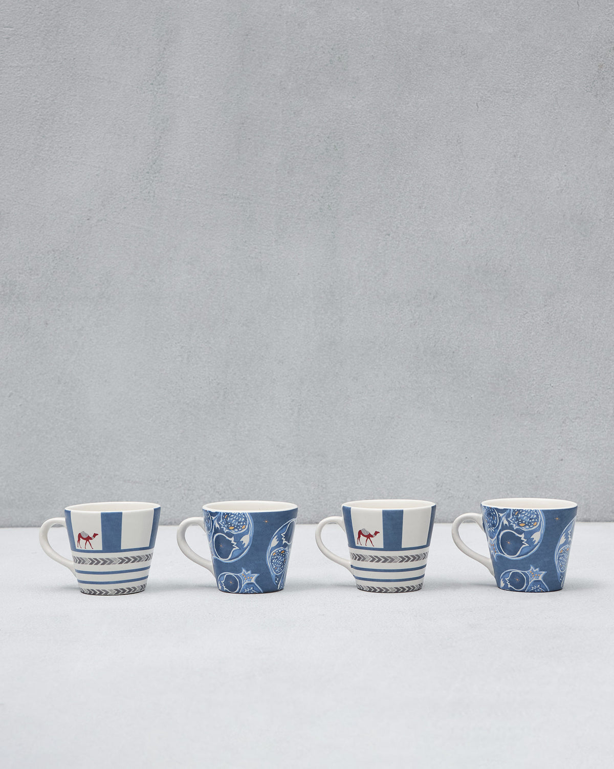 Set of four Desert Trail Espresso Mugs alternating camel and pomegranate designs.