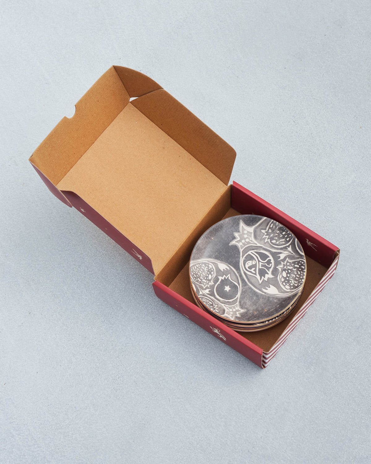Desert Trail Tea Plates stacked in an open burgundy gift box.