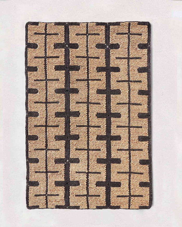 Marrakesh floor rug in beige and black with a geometric pattern, laid flat.
