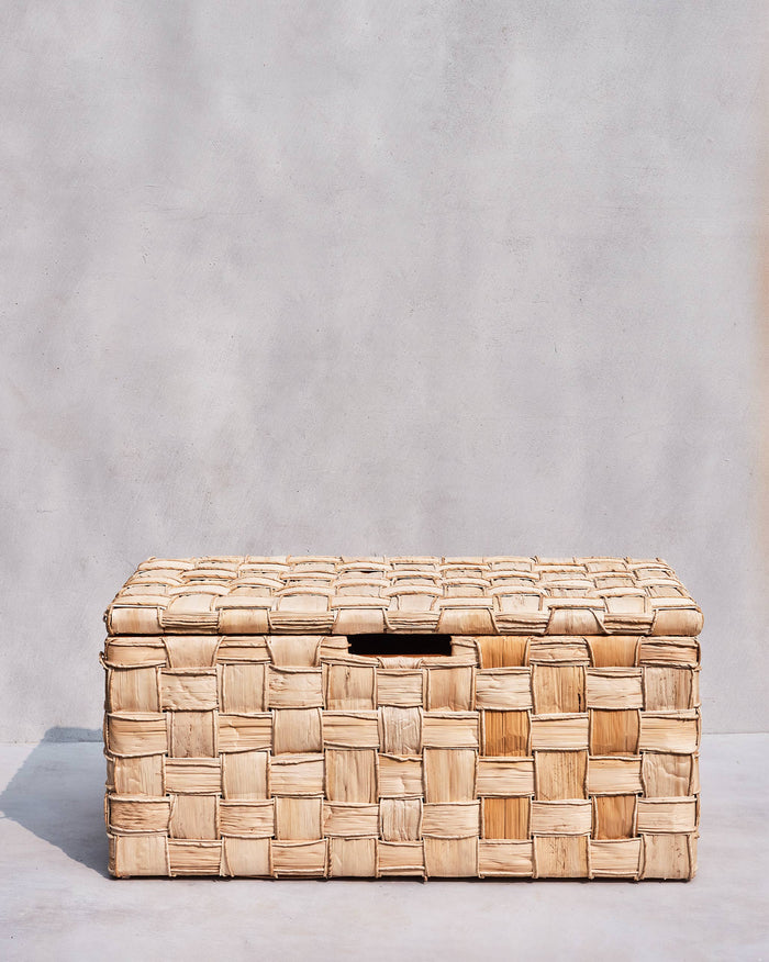 Large Mirage abaca trunk with natural basket-weave and a front cutout handle.