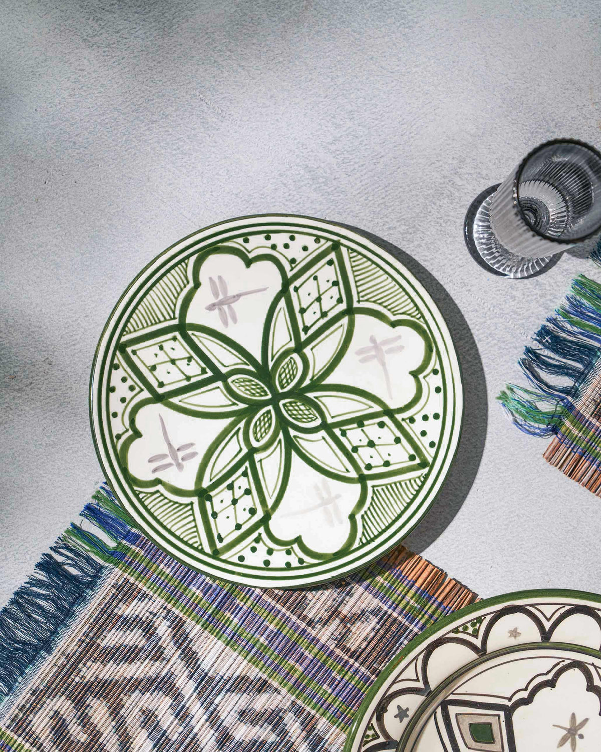 Mosaic Oasis Quarter Plate on a woven mat, seen from above.