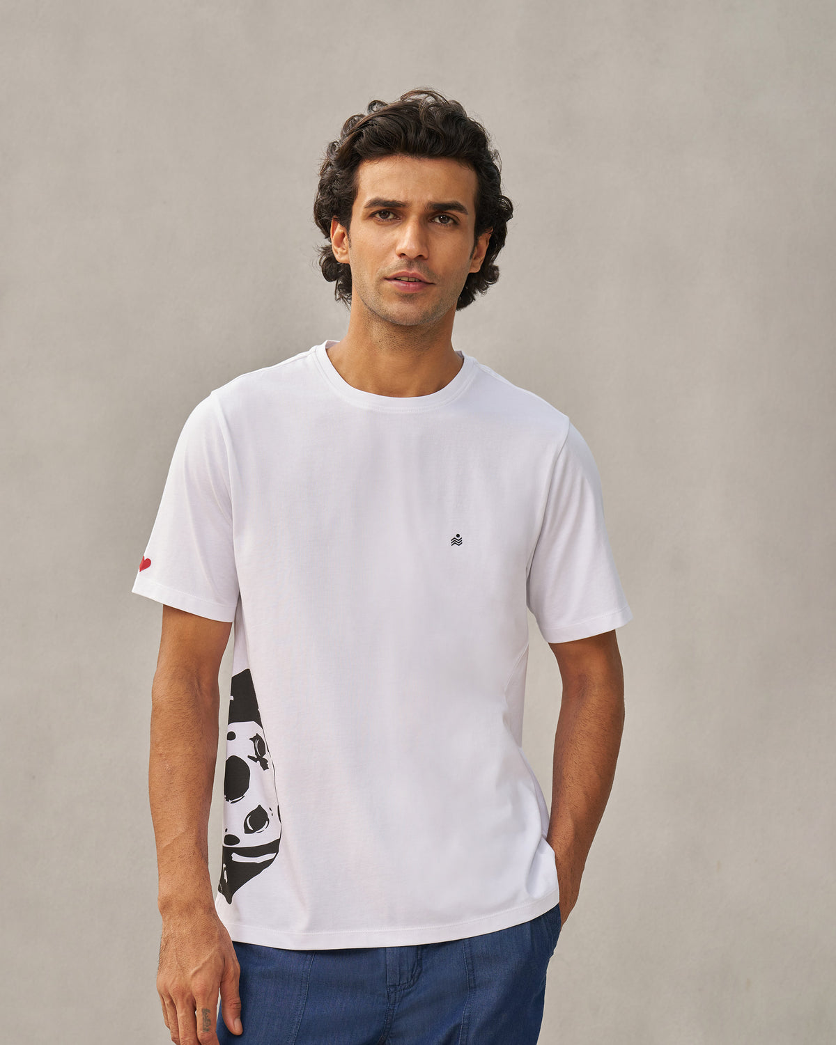 Person wearing a white Peekaboo Dalmation T-shirt with a large side graphic.