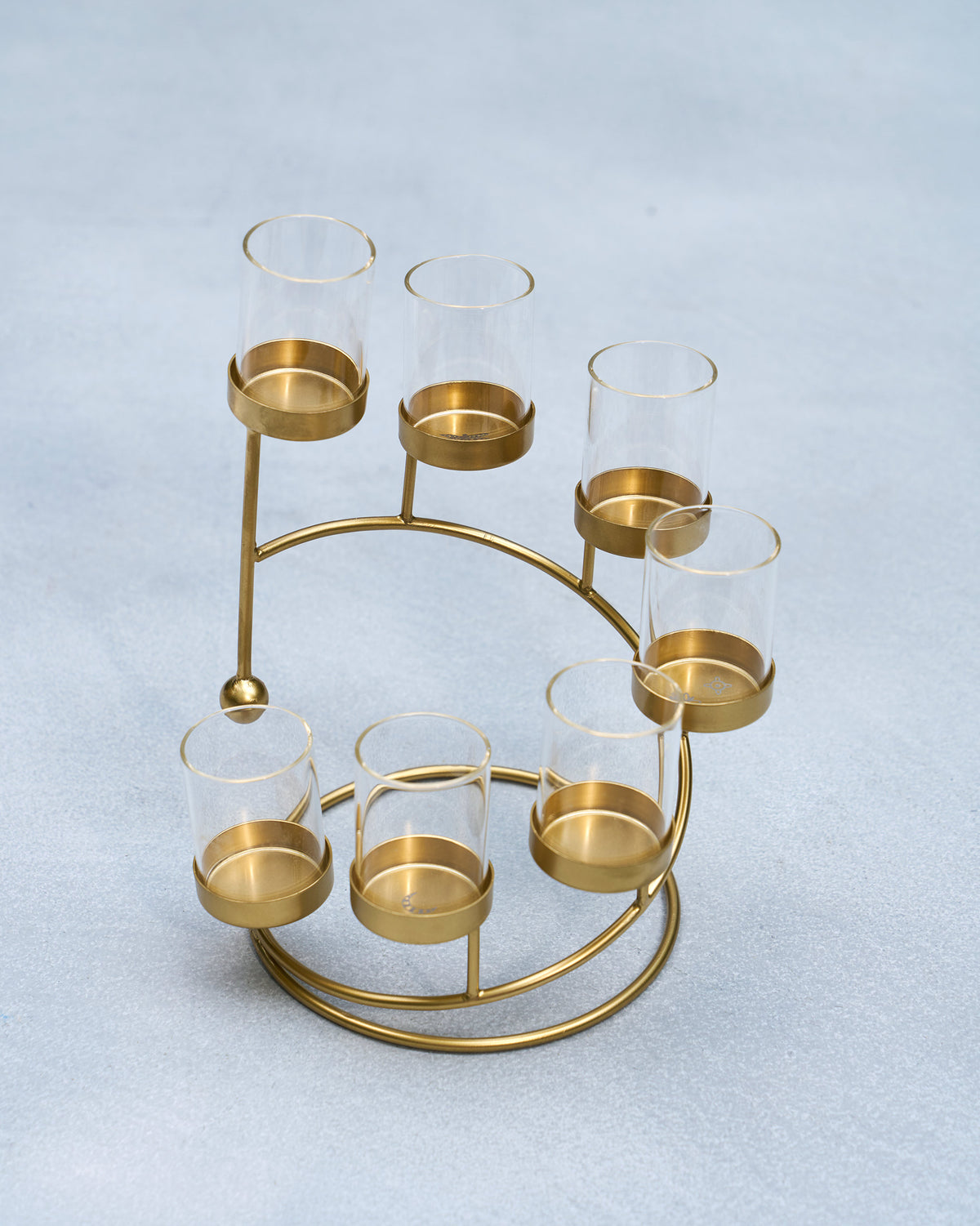 Amaryllis Tealight Holder with glass cups on a gold ring base.