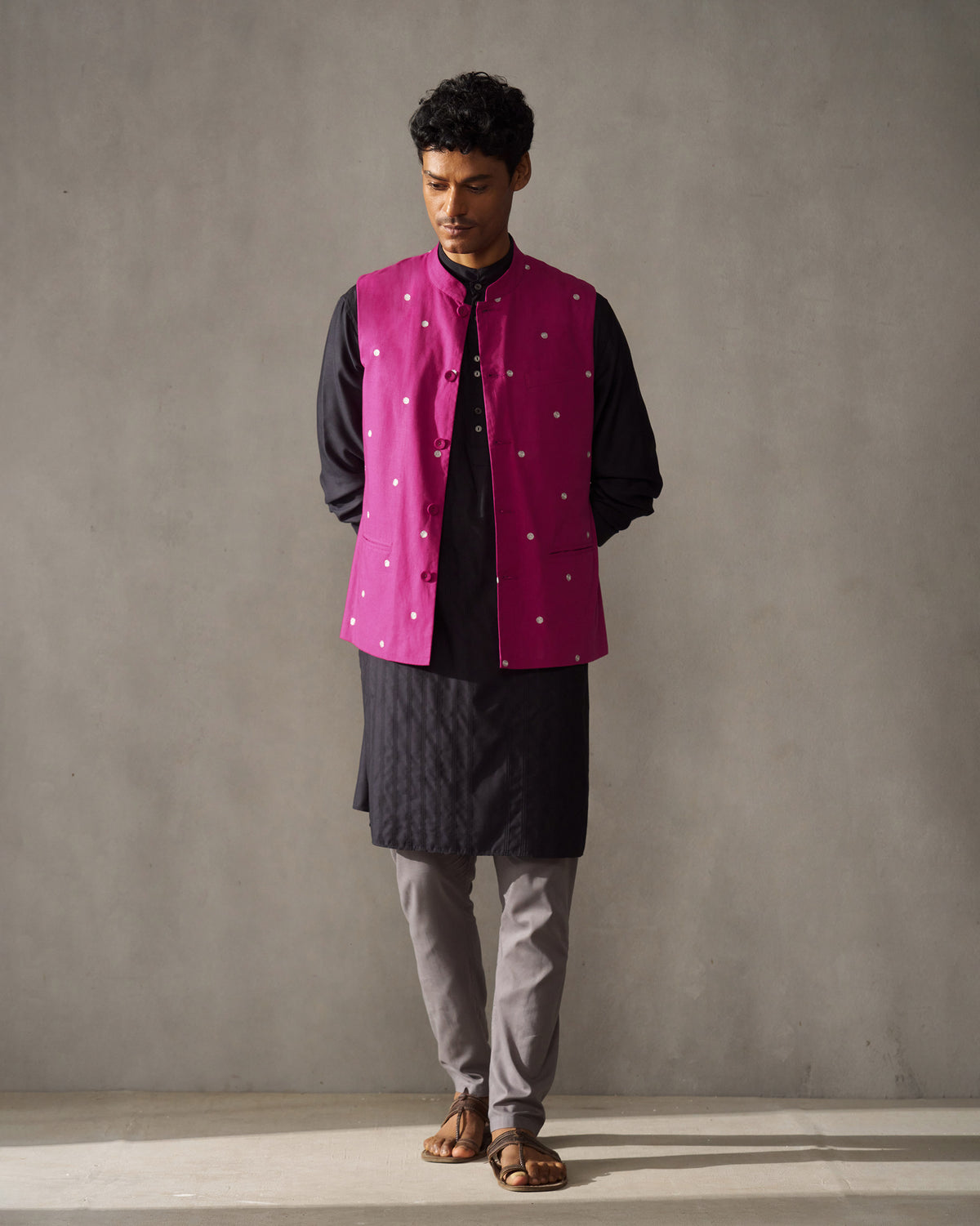 Magenta Nehru jacket with silver embroidery worn full length over a dark kurta.