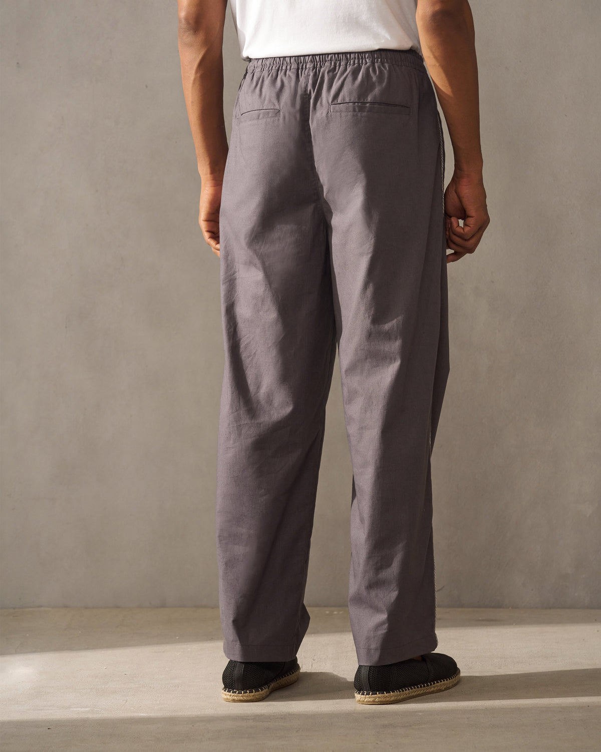 Back of charcoal Tom Trousers with back pockets.