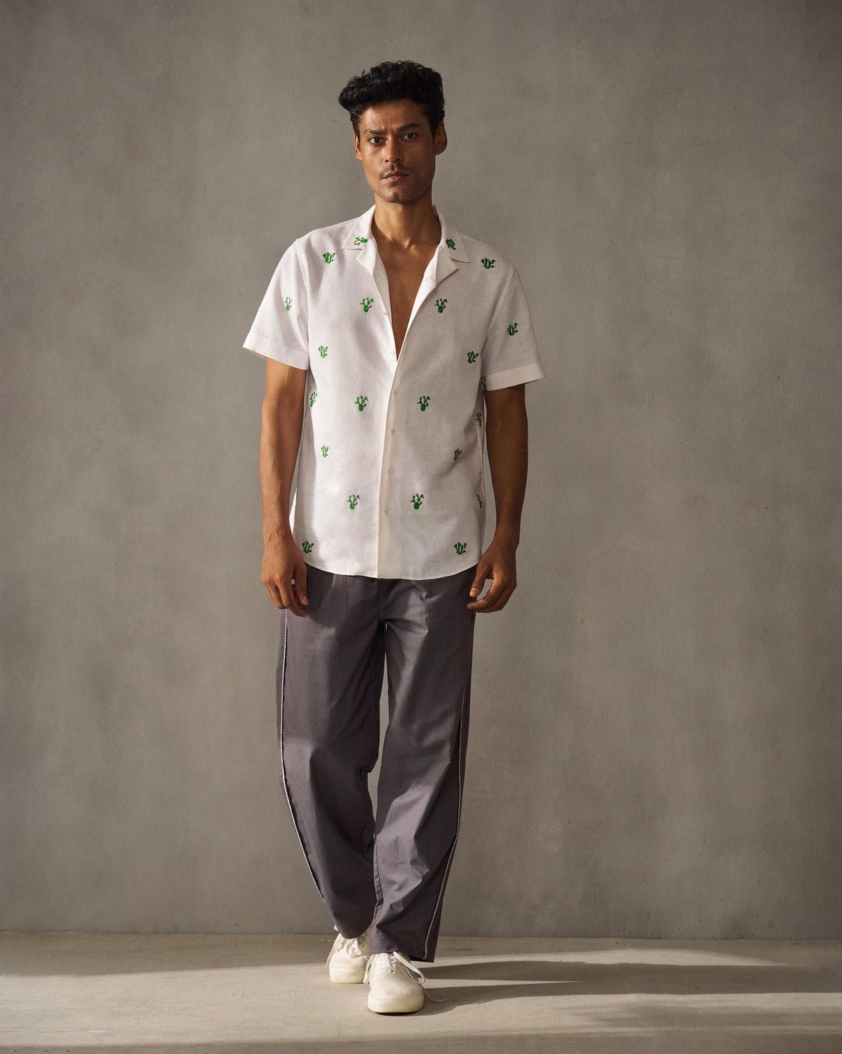 Full-length view of charcoal Tom Trousers worn by a person.