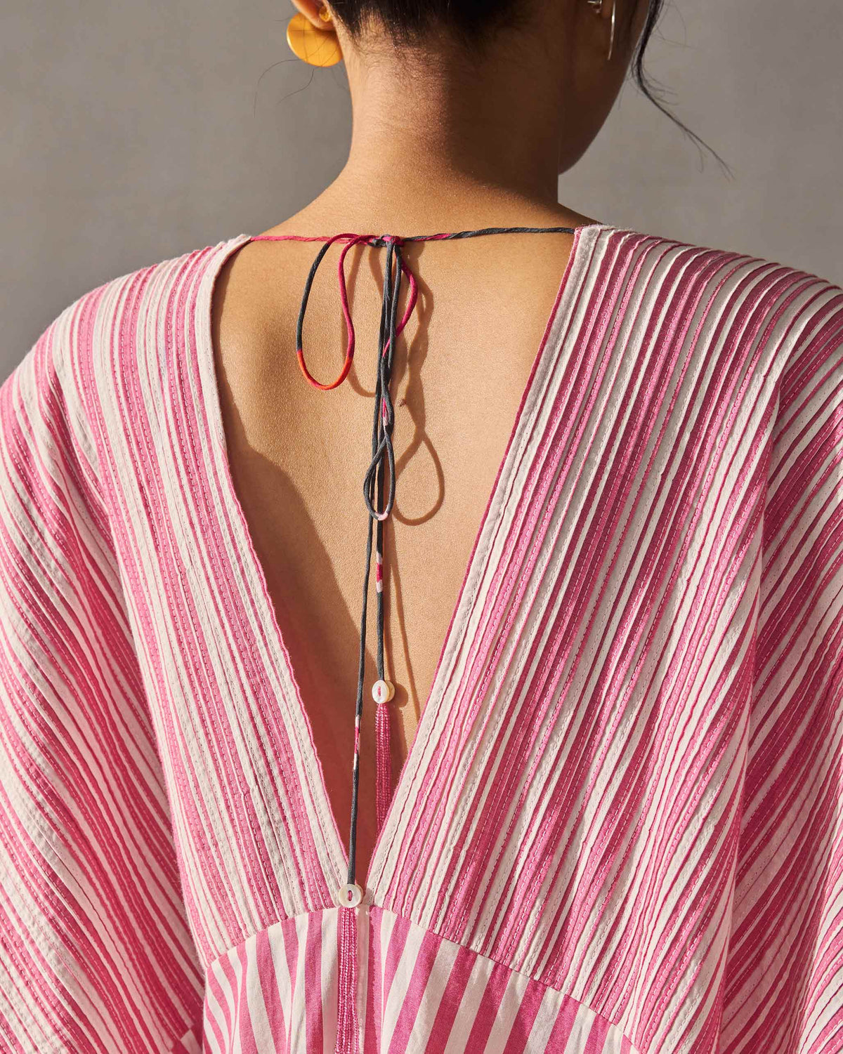 Close-up of the back of a Sarai Kaftan showing its V-back and cord tie.