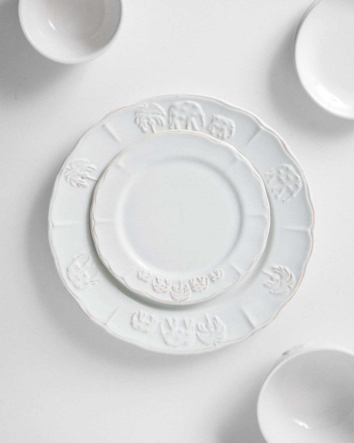 Ele Palm quarter plate stacked on a larger matching dinner plate.