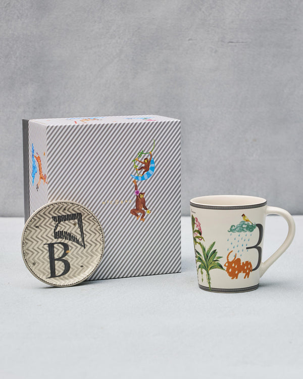 The B mug and coaster beside the striped gift box