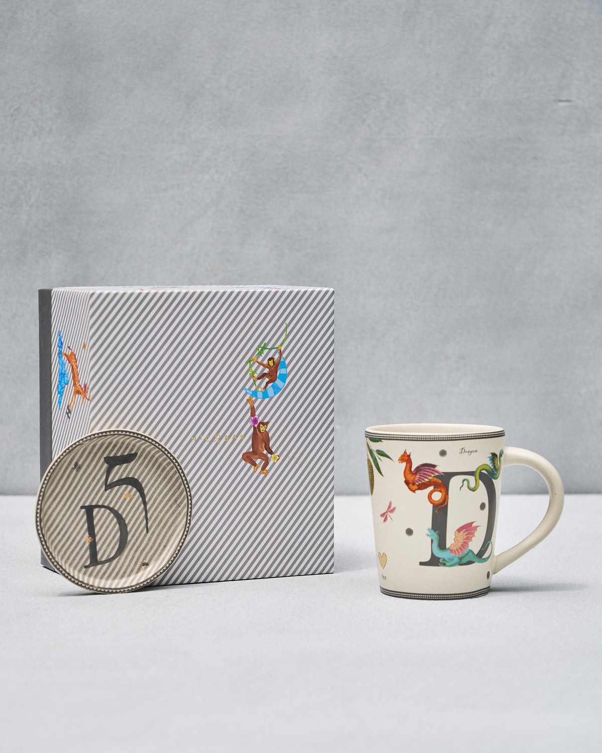 D Alphabet Set with dragon mug, striped coaster, and Nicobar gift box.