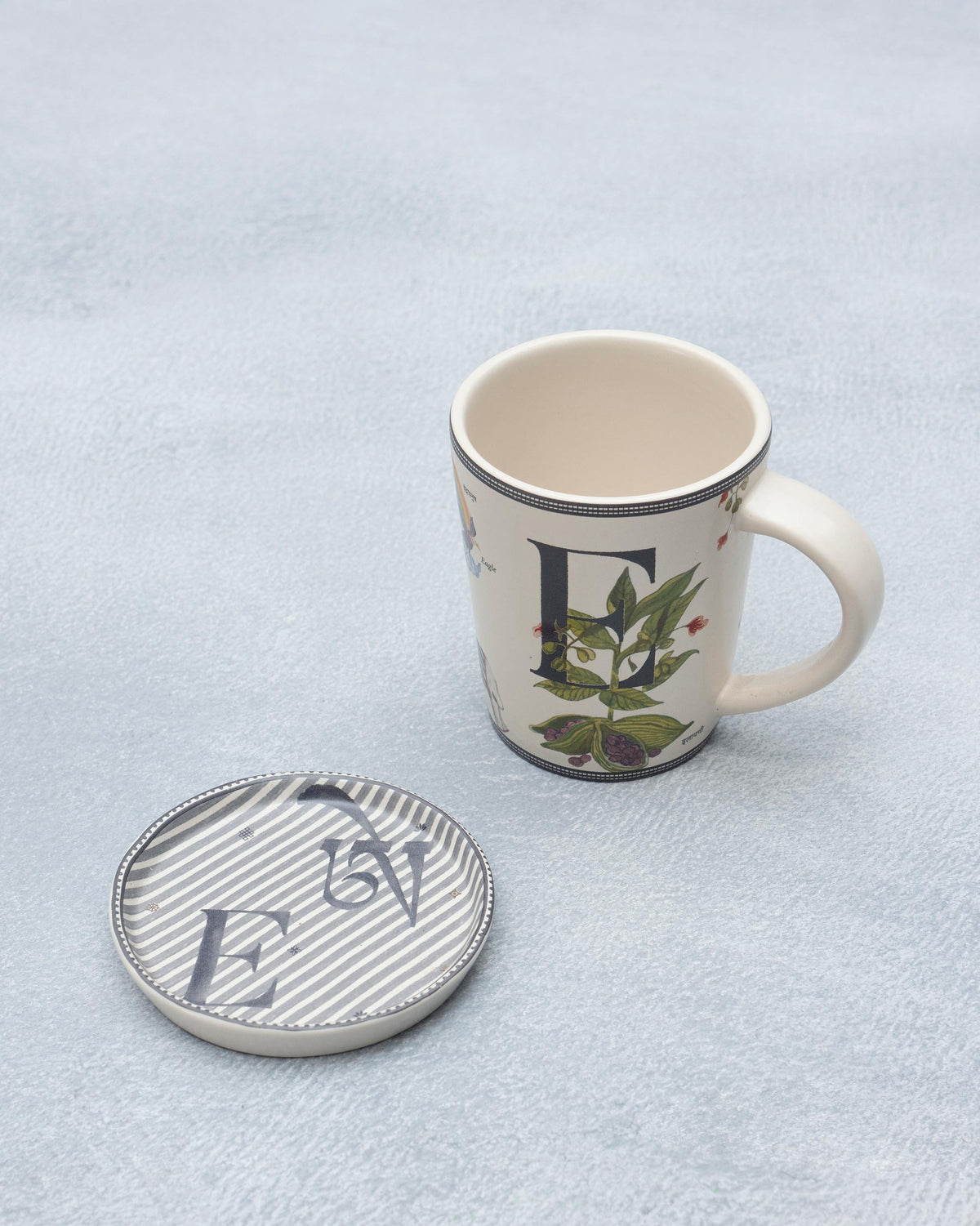 E Alphabet mug with botanical letter E and matching striped coaster.
