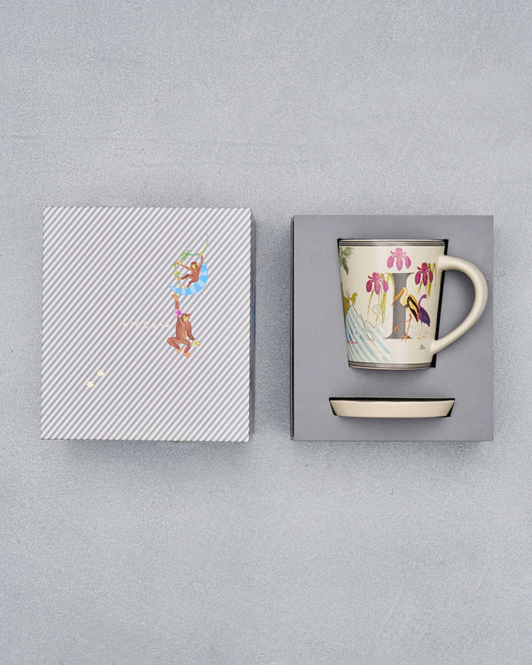 The open box with the mug and coaster inside