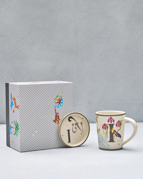 The I mug and coaster beside the striped gift box