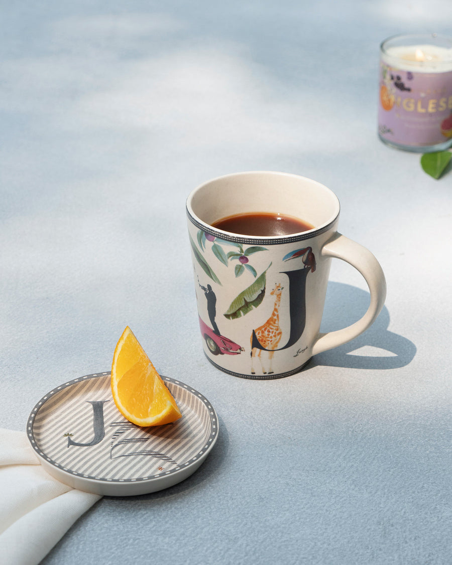 The J mug of coffee beside its matching J coaster