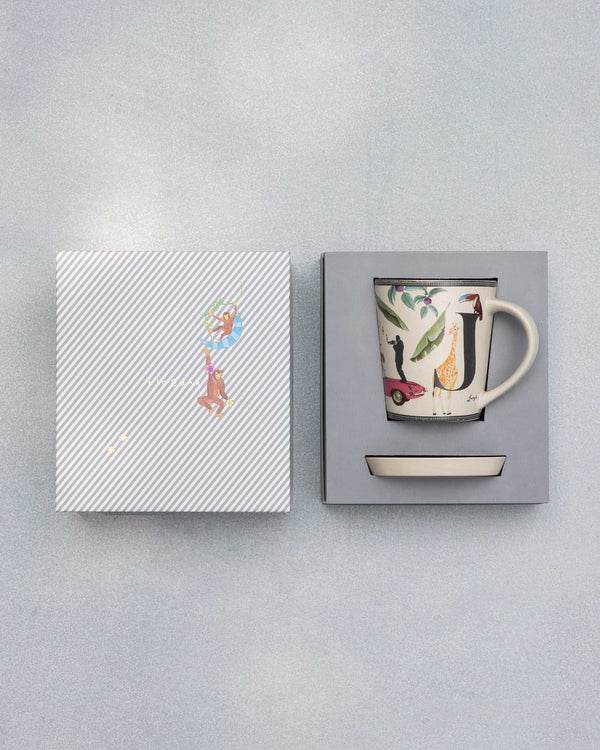 The open box with the mug and coaster inside