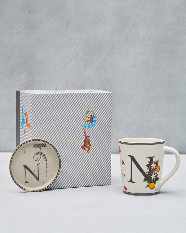 The N mug and coaster beside the striped gift box