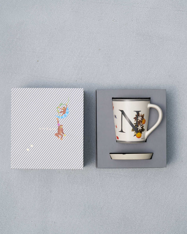 The open box with the mug and coaster inside