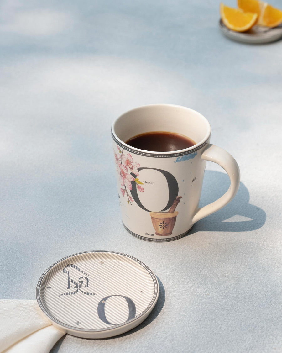 The O mug of coffee beside its matching O coaster