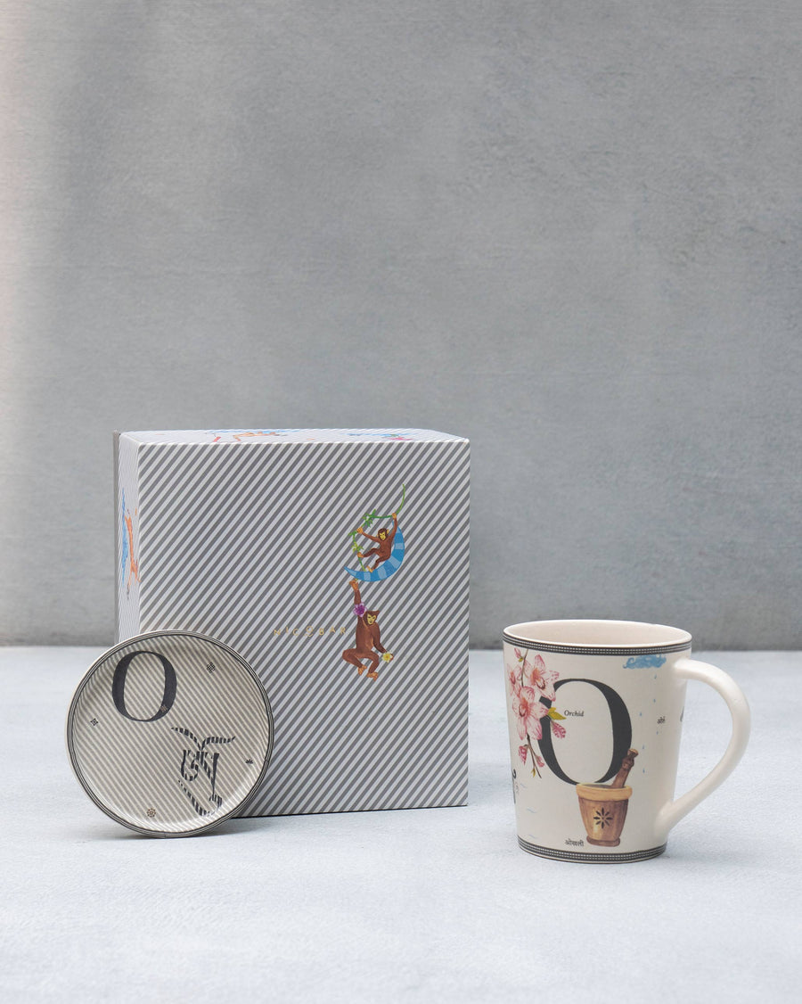 The O mug beside its coaster