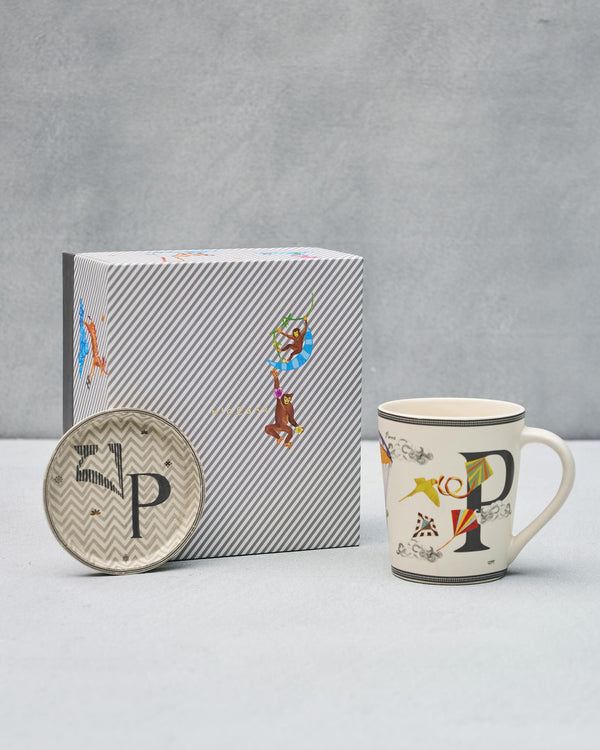 The P mug and coaster beside the striped gift box