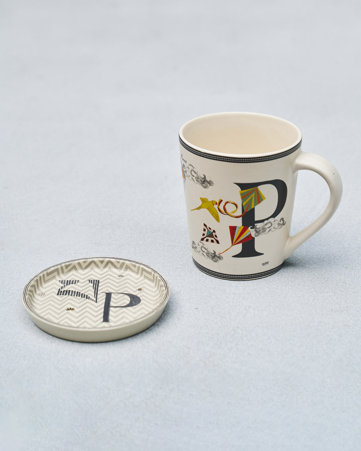 Cream P alphabet mug with kite motifs paired with a matching P coaster.