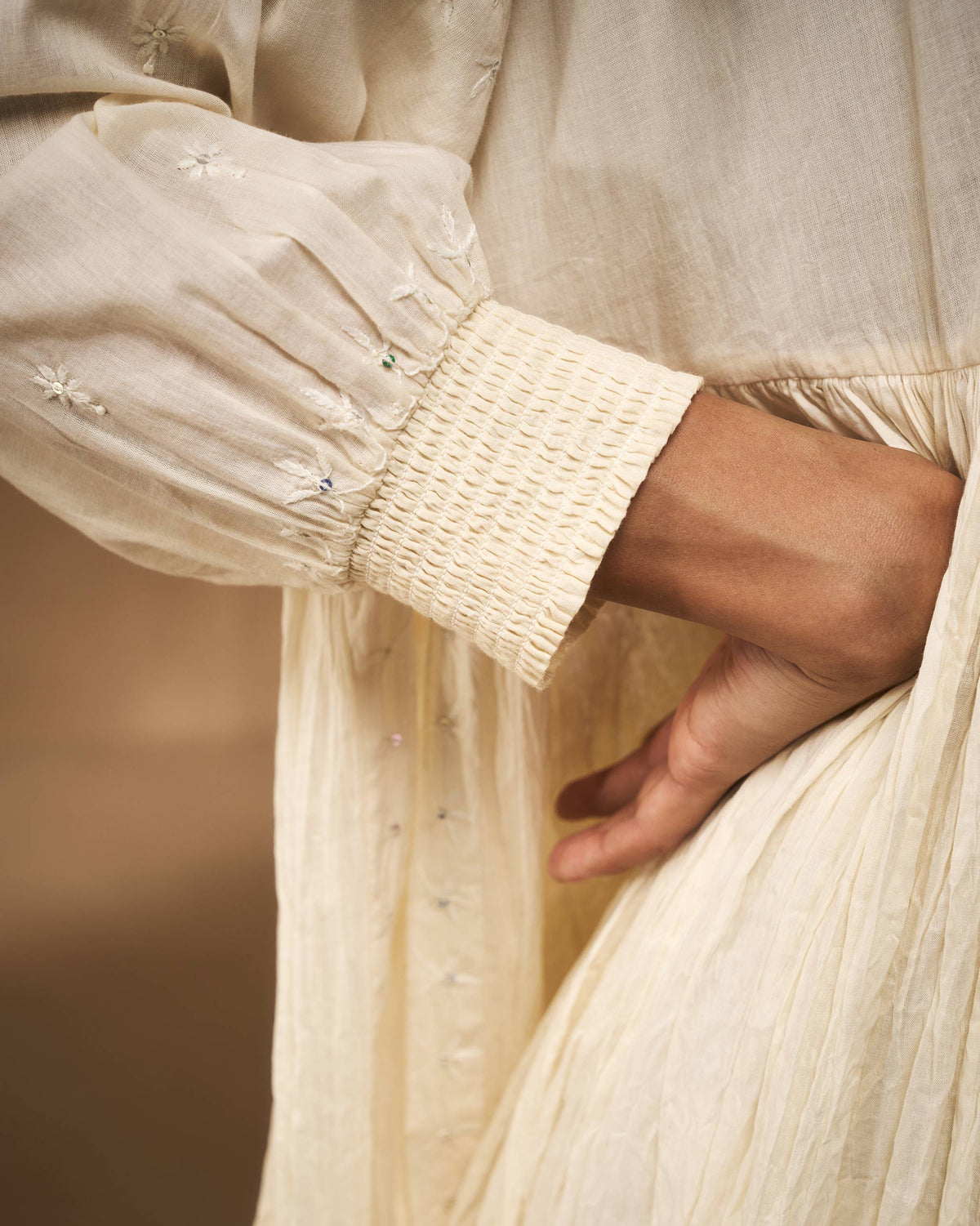 Close-up of chikankari embroidery and a smocked cuff on an ivory Taabir top.