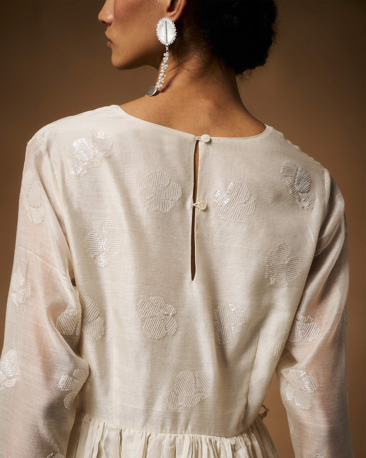 Close-up of the back keyhole buttons on an ivory Amaya kurta.