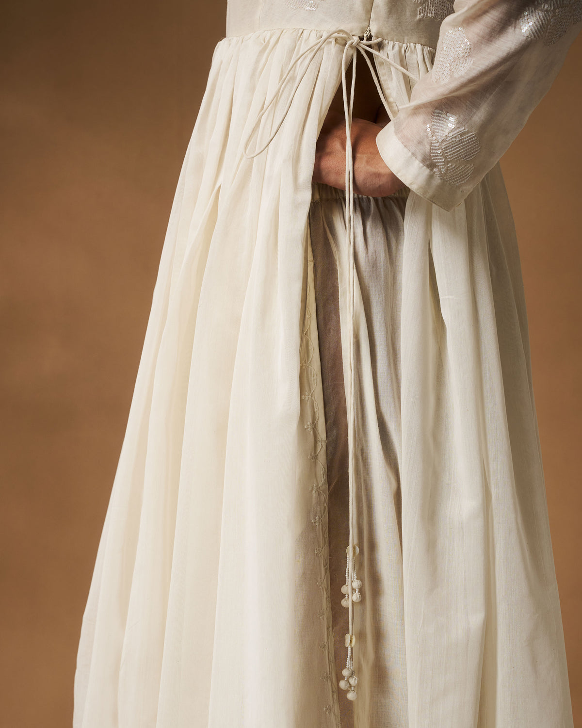 Close-up of the side waist ties on an ivory Amaya kurta.