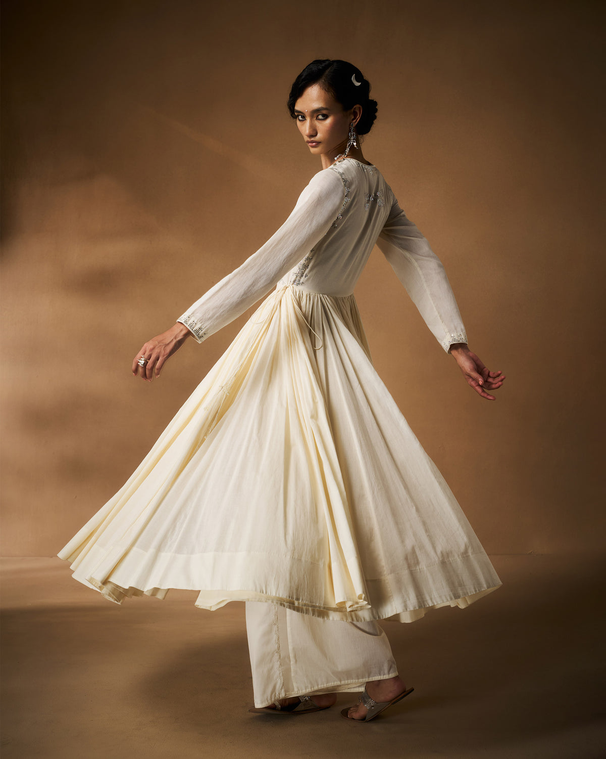 Person spinning in an ivory Aafreen Angrakha showing the flared skirt.