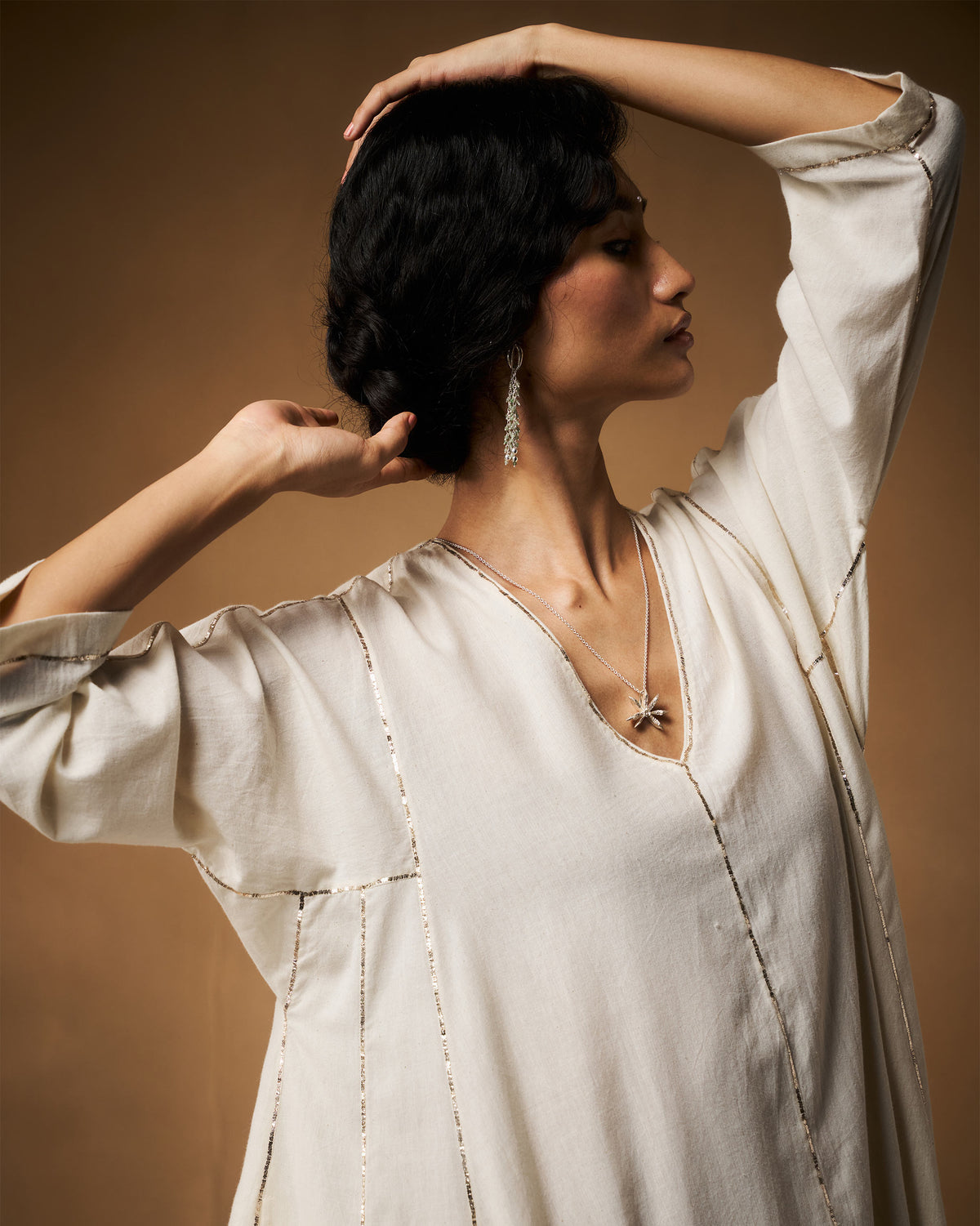 Side profile of an ivory Aheli Kurta with vertical silver embroidery.