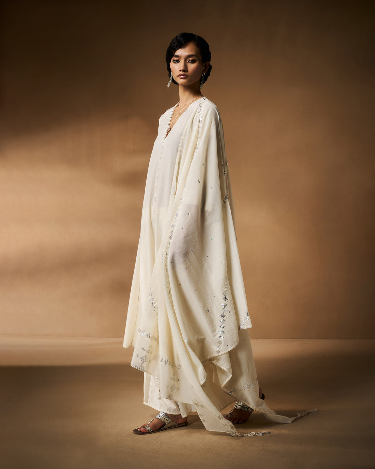 Ivory Aheli Kurta worn with a flowing silver-embroidered dupatta.
