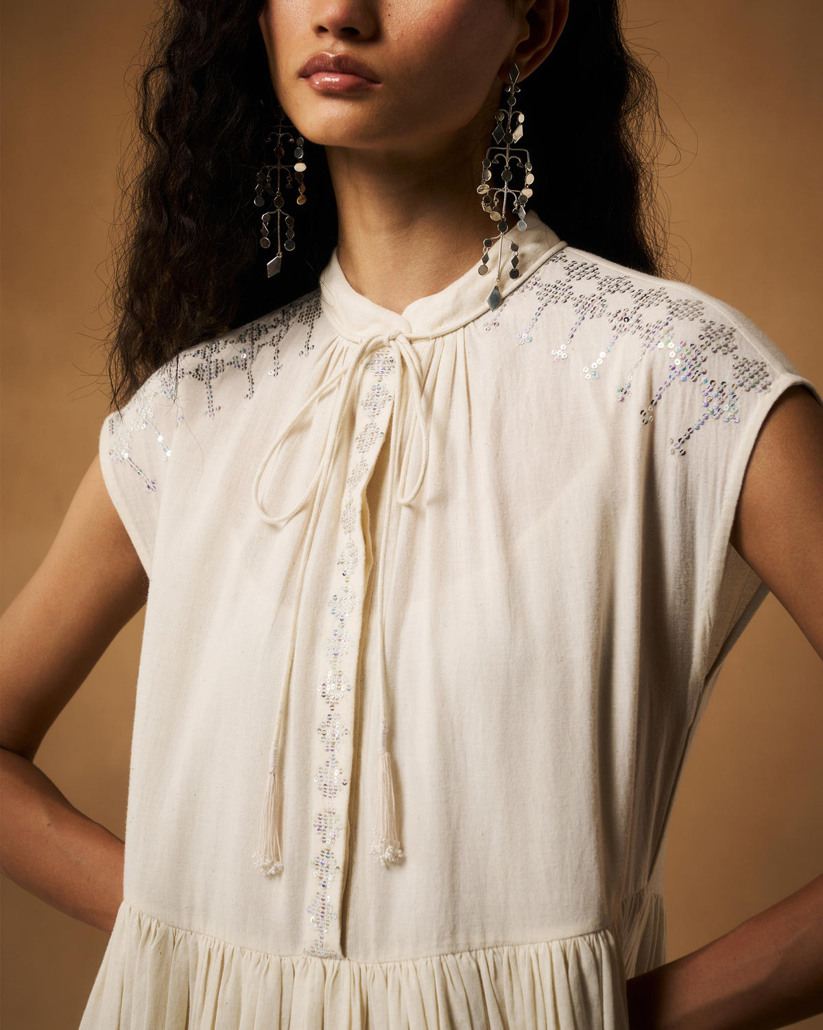 Close-up of silver sequin embroidery on an ivory Mina Dress.