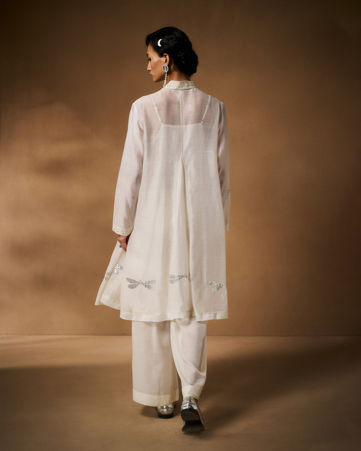 Back of an ivory Pavi overlay with silver dragonfly motifs at the hem.