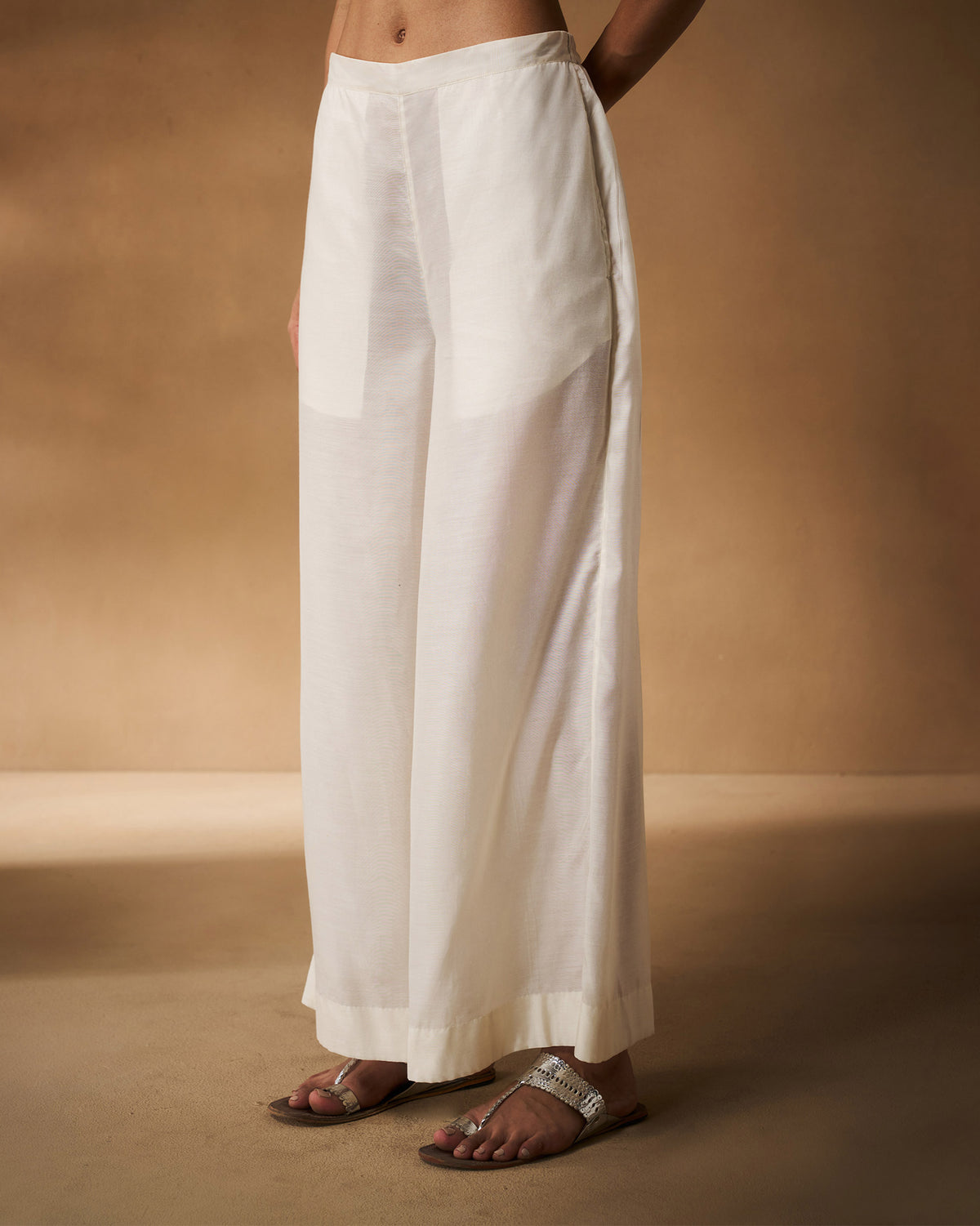 Three-quarter view of ivory Basic pyjamas with a wide-leg fit.