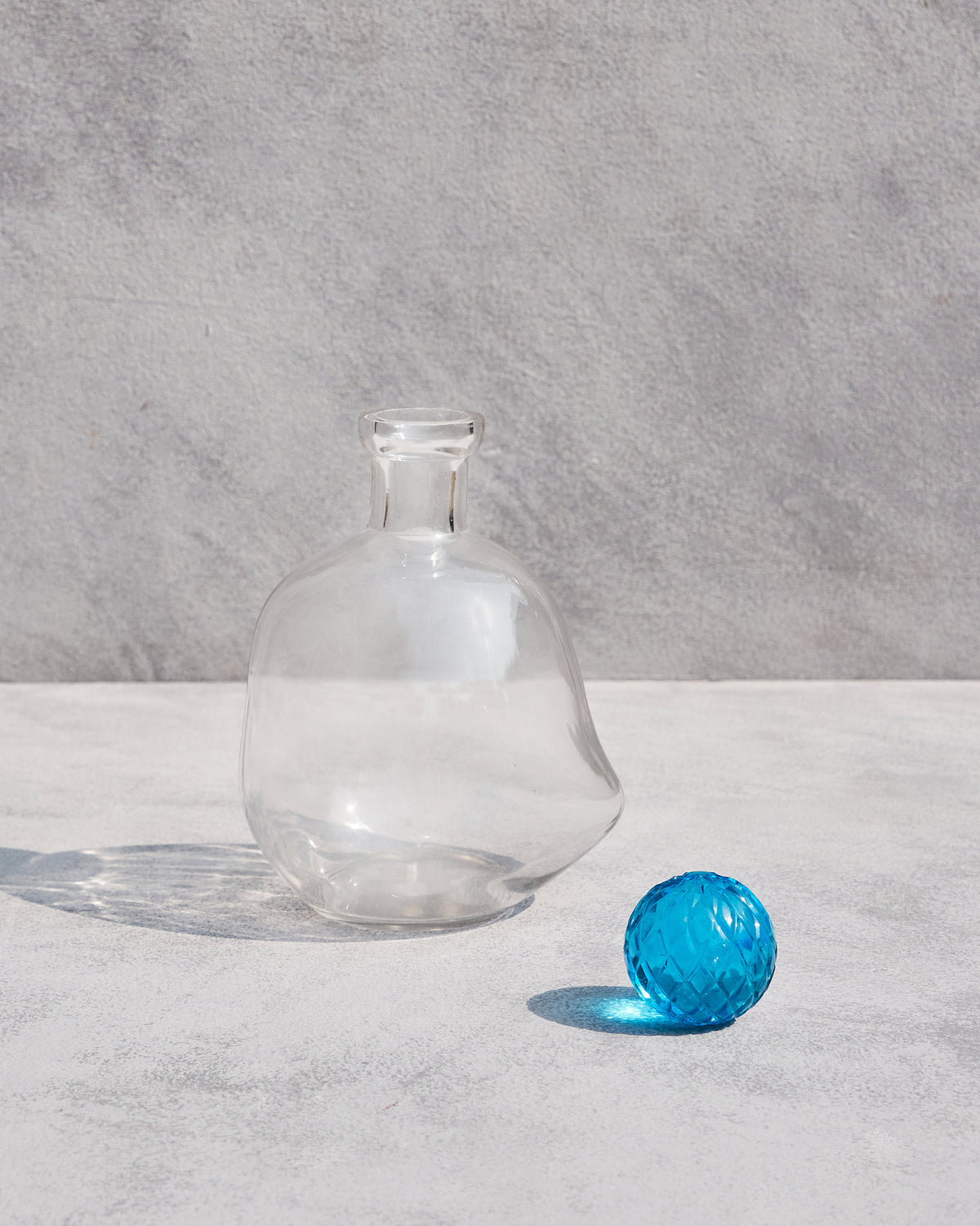Revel Decanter with its blue faceted stopper set beside it.