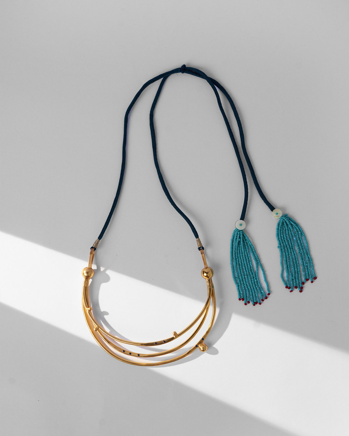 Gold Celestial choker with crescent tiers and turquoise beaded tassels.