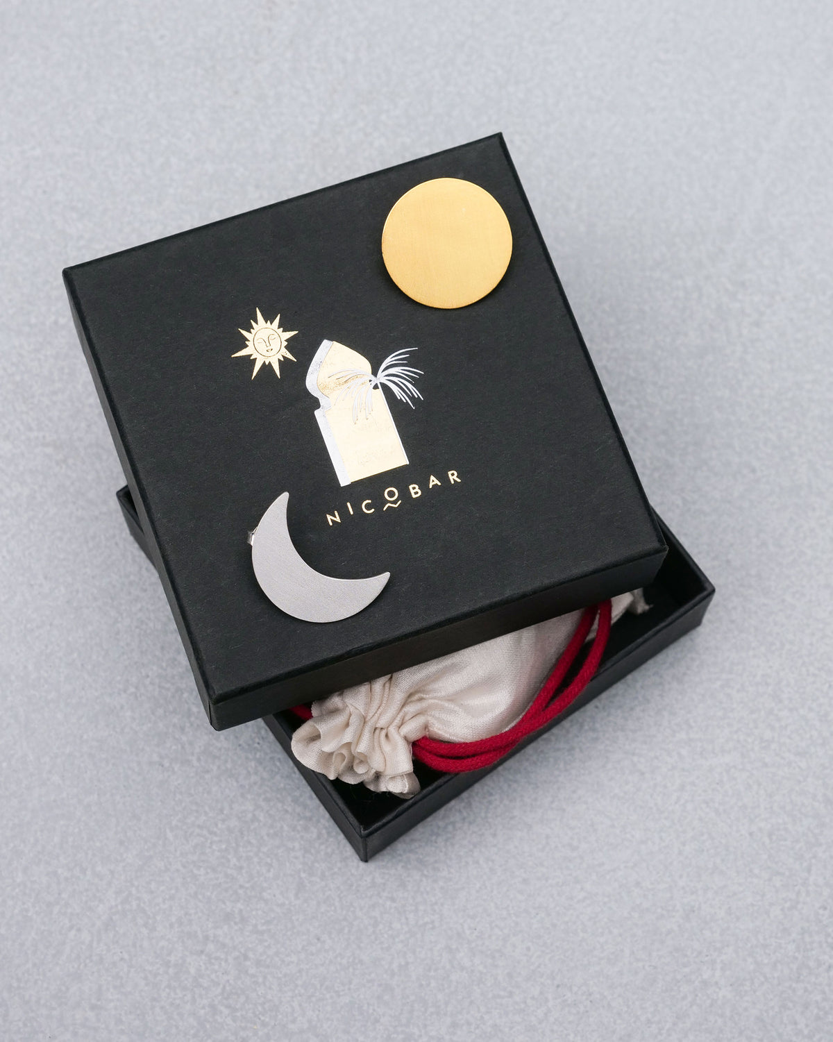 Sun Moon earrings with a black Nicobar gift box.