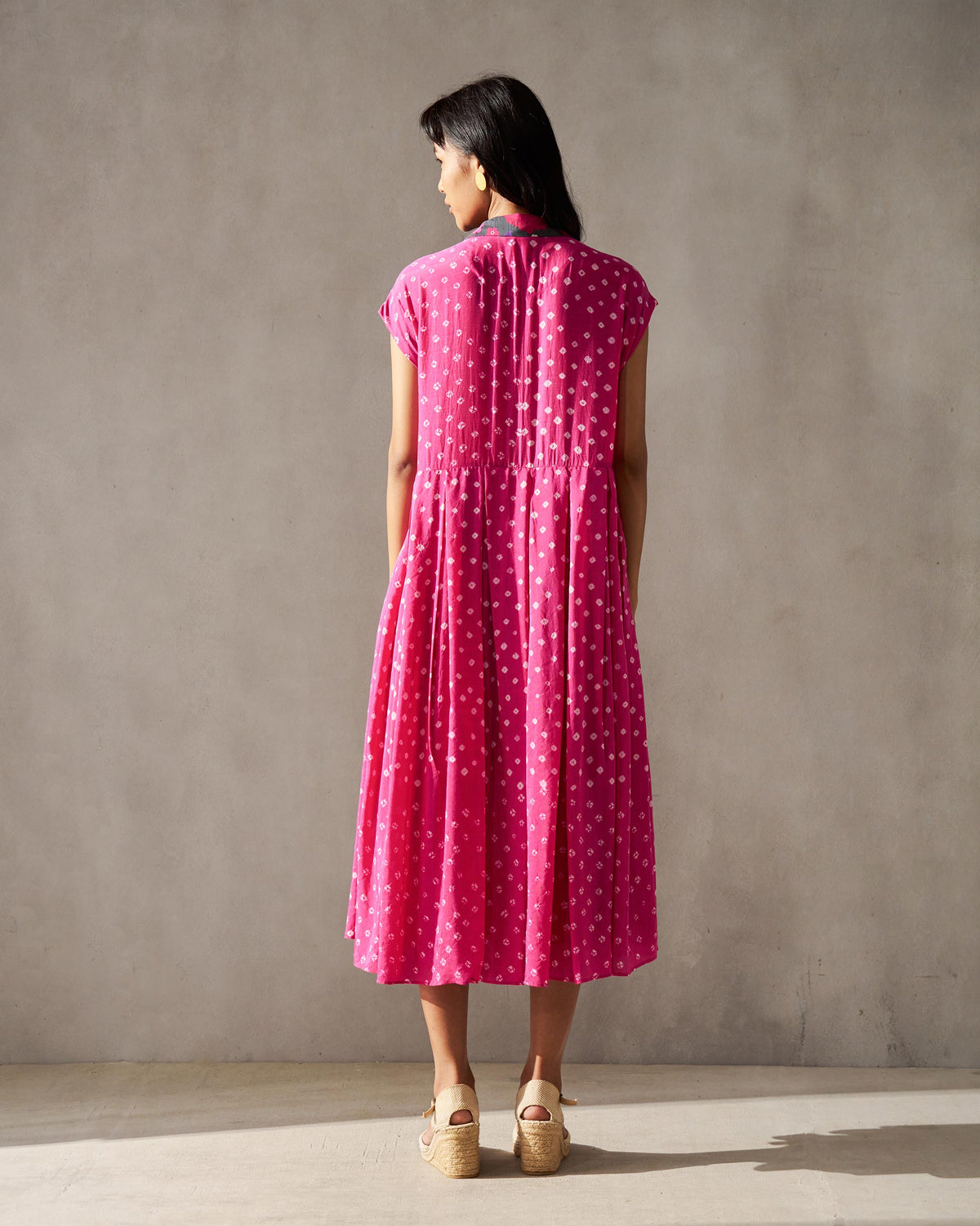 Back of a fuchsia Midsummer dress with a contrast collar and gathered waist.