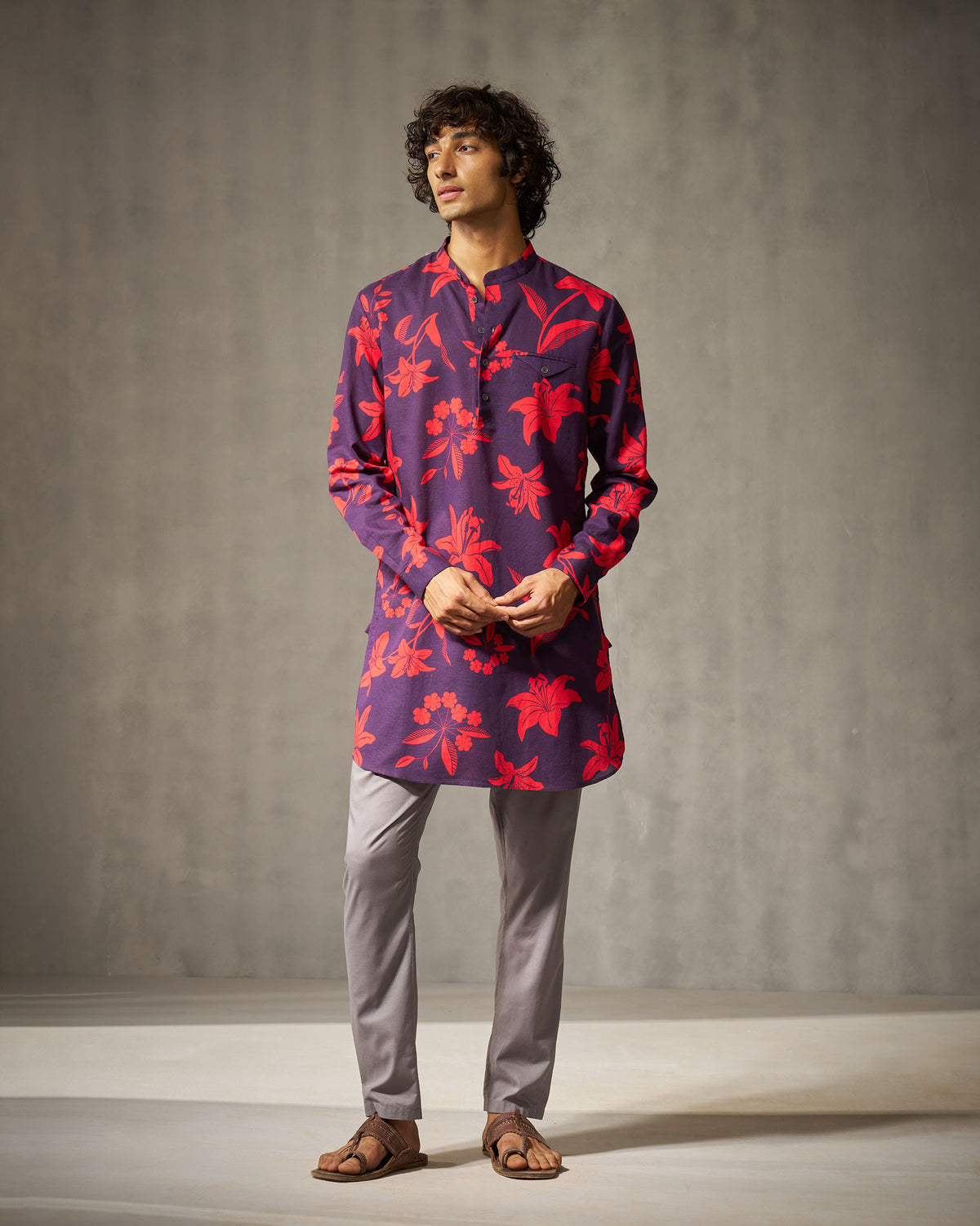 Person wearing a mid-thigh purple Fort Kurta with red floral print.