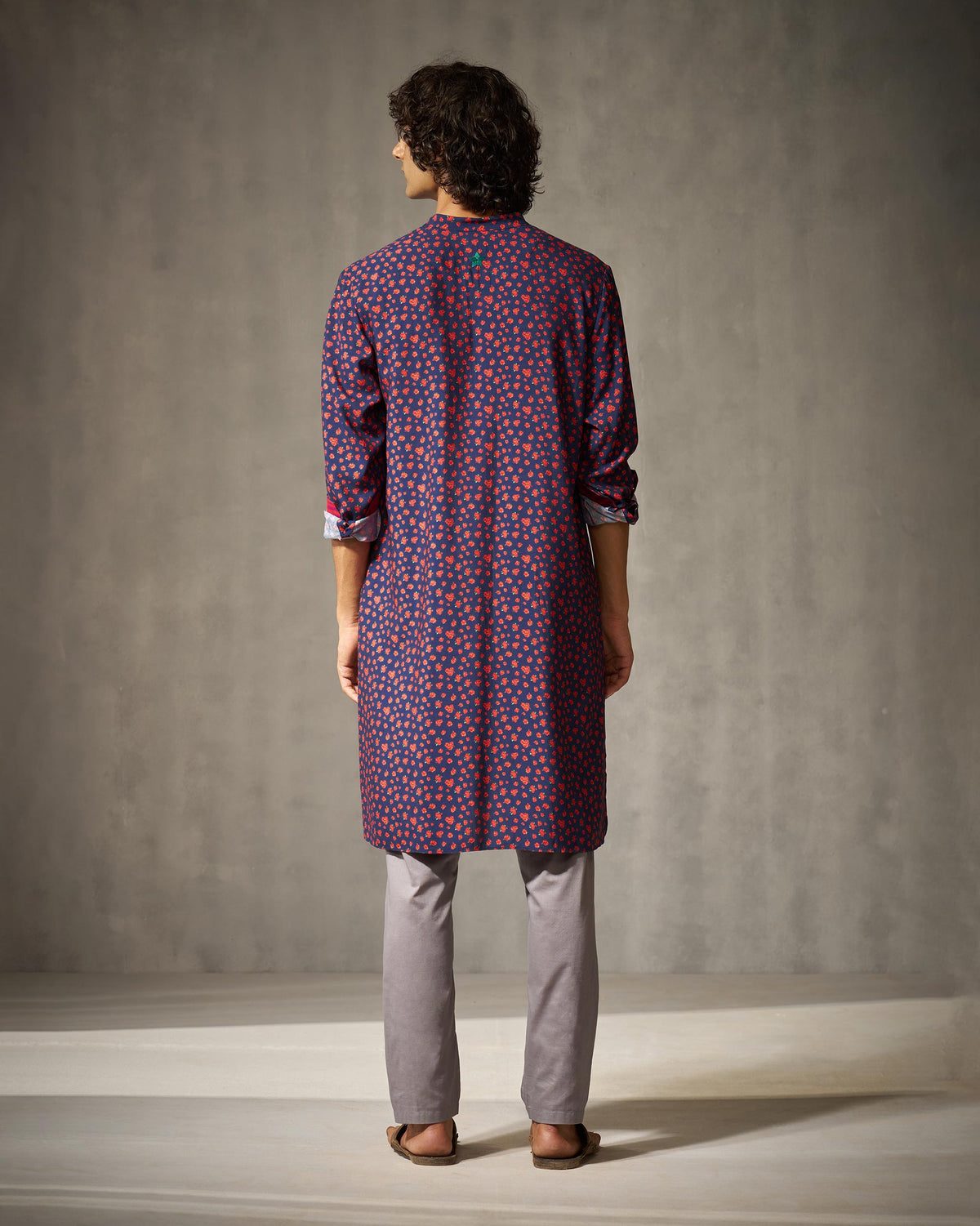 Back of a navy Bageecha kurta with an all-over red print.