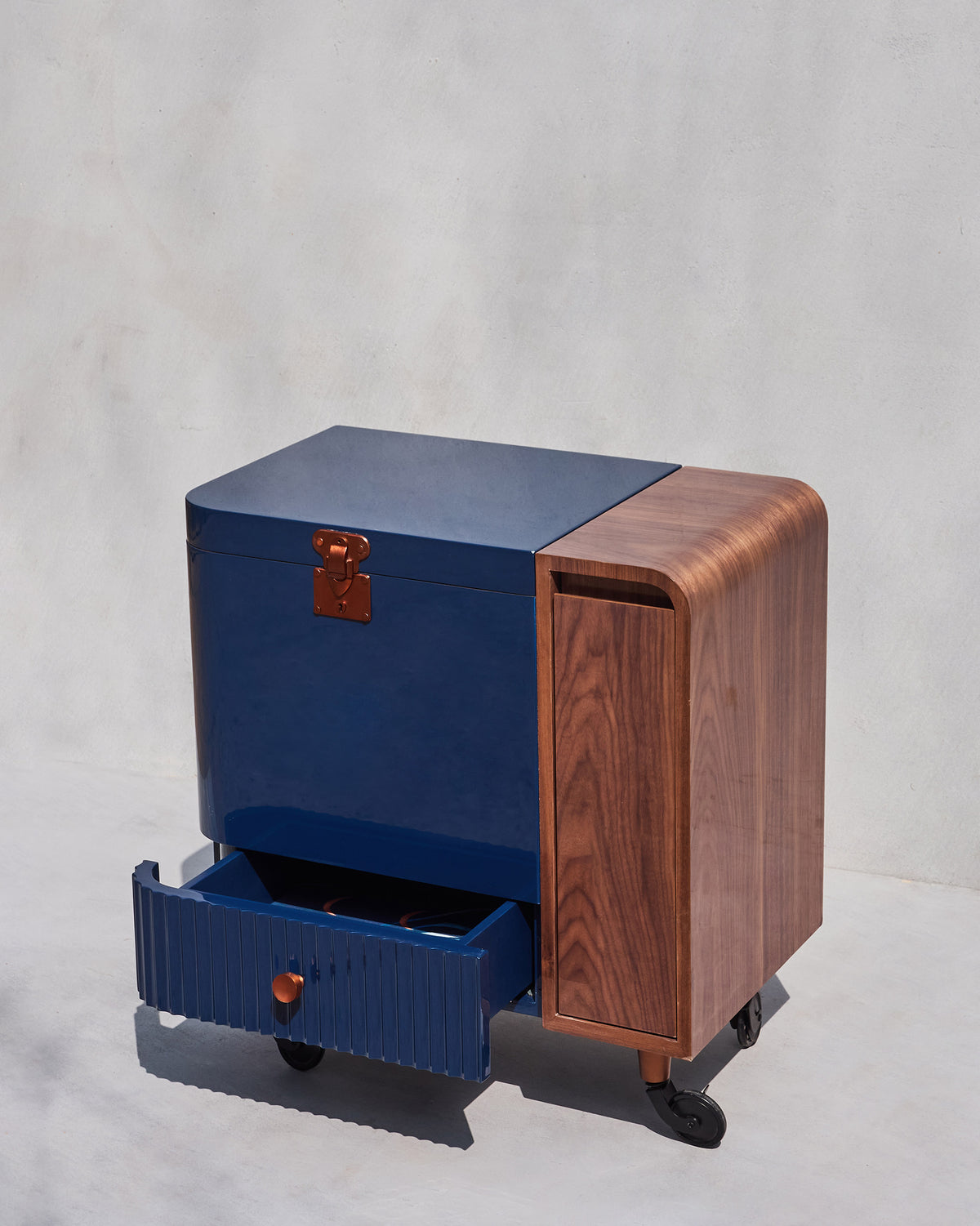Contours of Time bar trolley with its fluted navy drawer pulled open.
