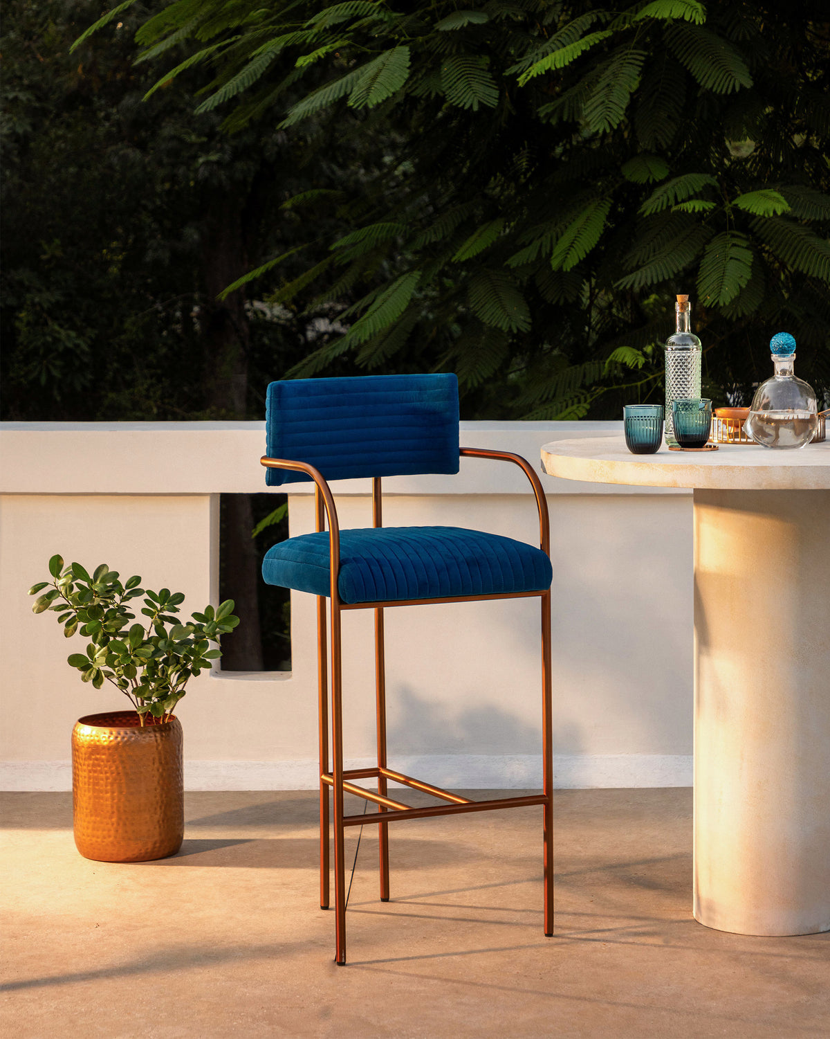 Blue Contours of Time high chair with channel tufting and a copper frame.