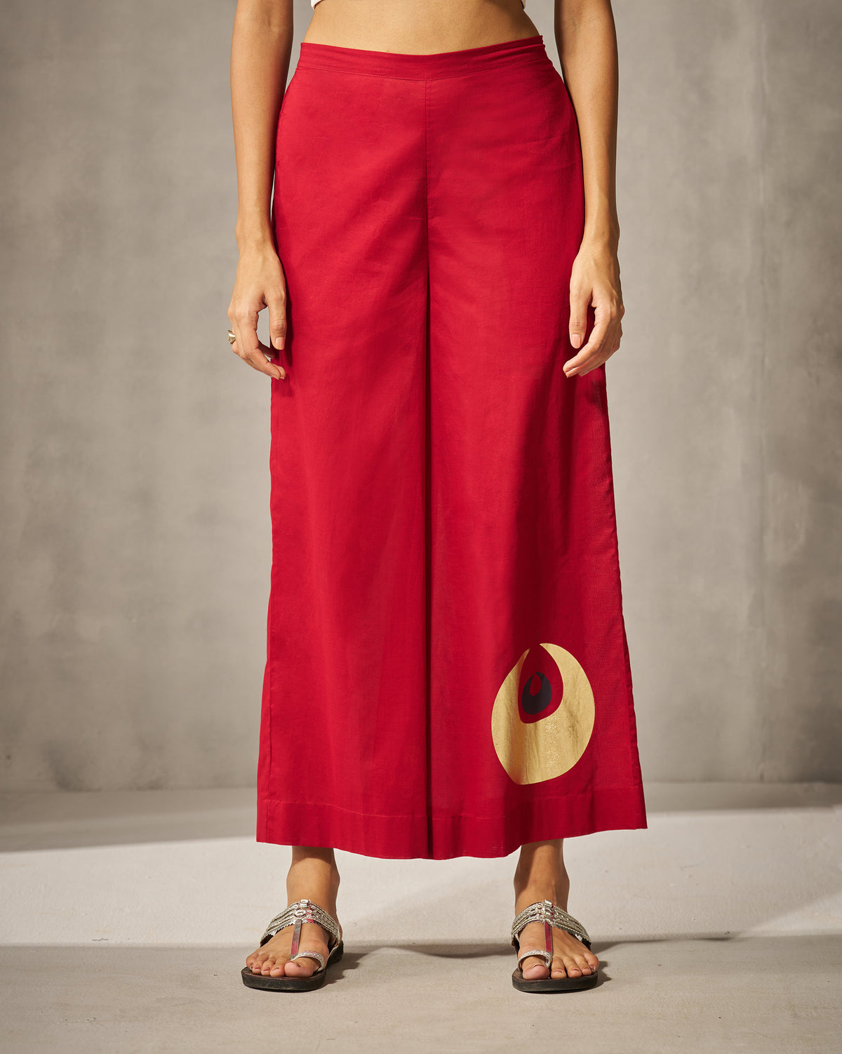 Red Basic pyjamas with a wide-leg fit and gold circle motif.