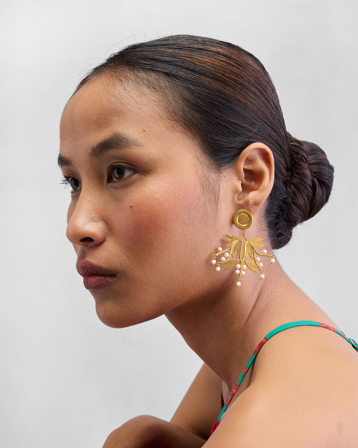 Side view of Anaar Cluster Earring worn, showing the gold leaf drop below the ear.