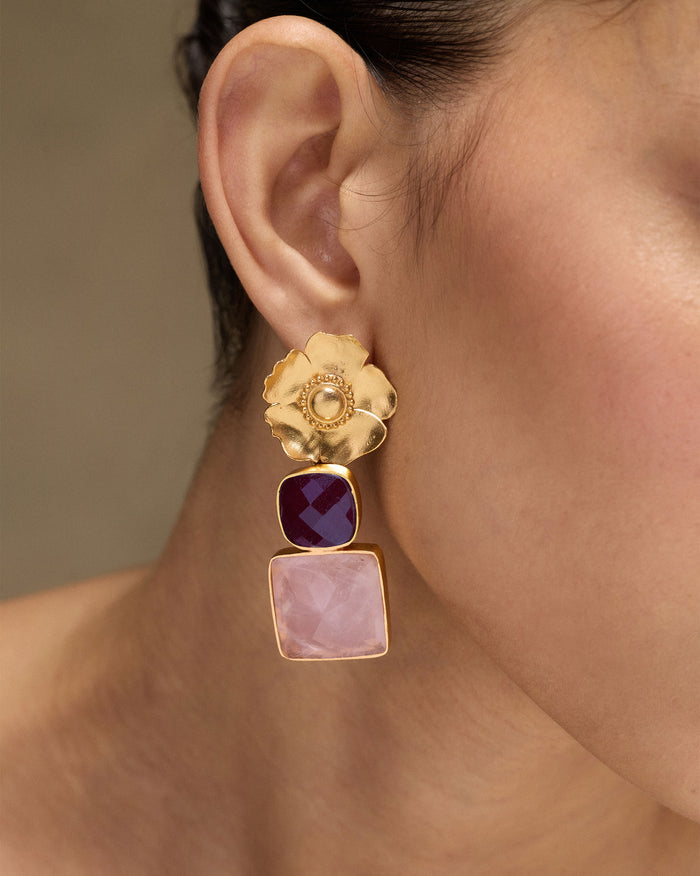 Side profile of gold dessert rose ruby drops with pink stone.