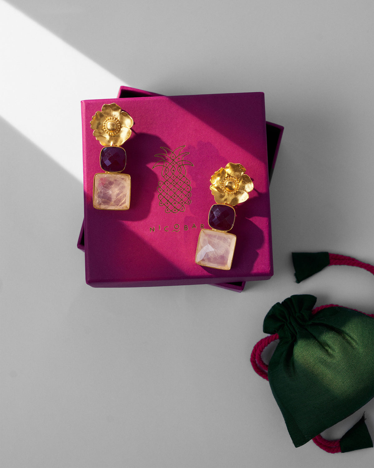 Gold dessert rose ruby drops on a purple Nicobar gift box.