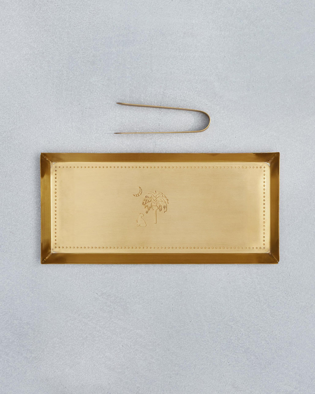 Gold Sahara cookie tray with palm motif and matching U-shaped tongs.
