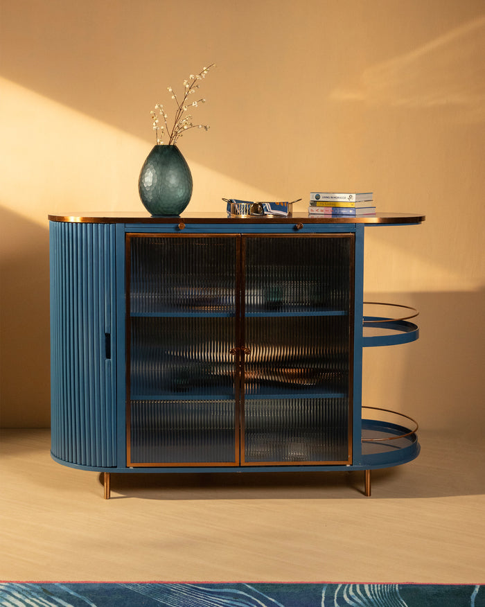 Blue Contours of Time cabinet with fluted glass doors and open curved shelves.