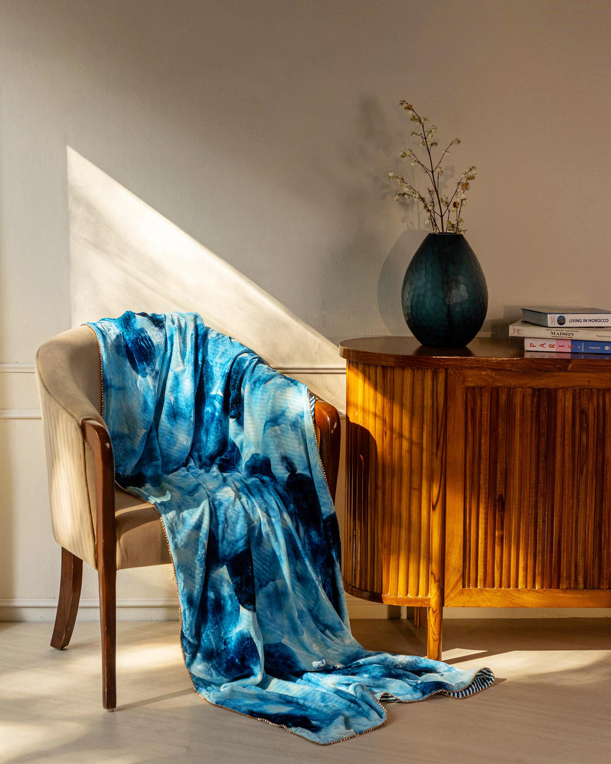 Pacific throw in blue and white draped over a chair.